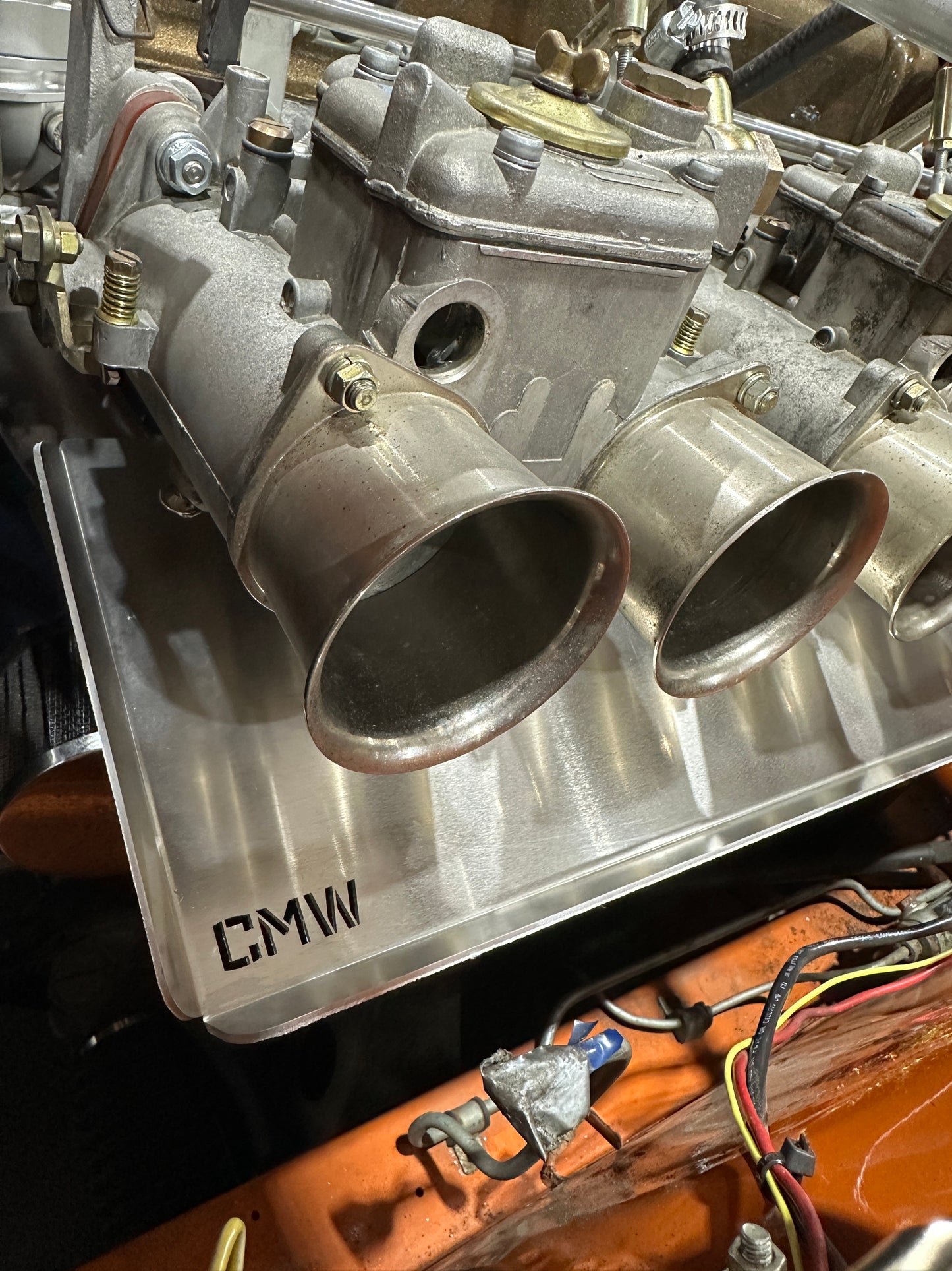 Close-up of carburetor intake manifold on CMW aluminum plate, car engine detail